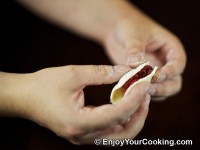 Fold dough circle in half, arrange edges together