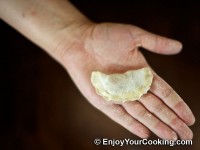 Dust each dumpling with flour and put on the wooden board