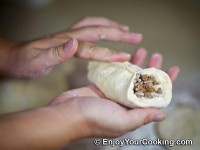 Fold dough circle in half and seal sides together from beginning to the end