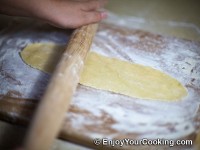 Roll a dough ball into thin long sheet
