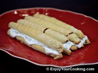 Generously cover with frosting and put second layer of sticks