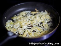Peel and quarter onions, fry them with oil until yellow and soft