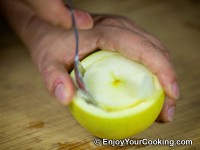 Using a spoon carefully loose the apple core up